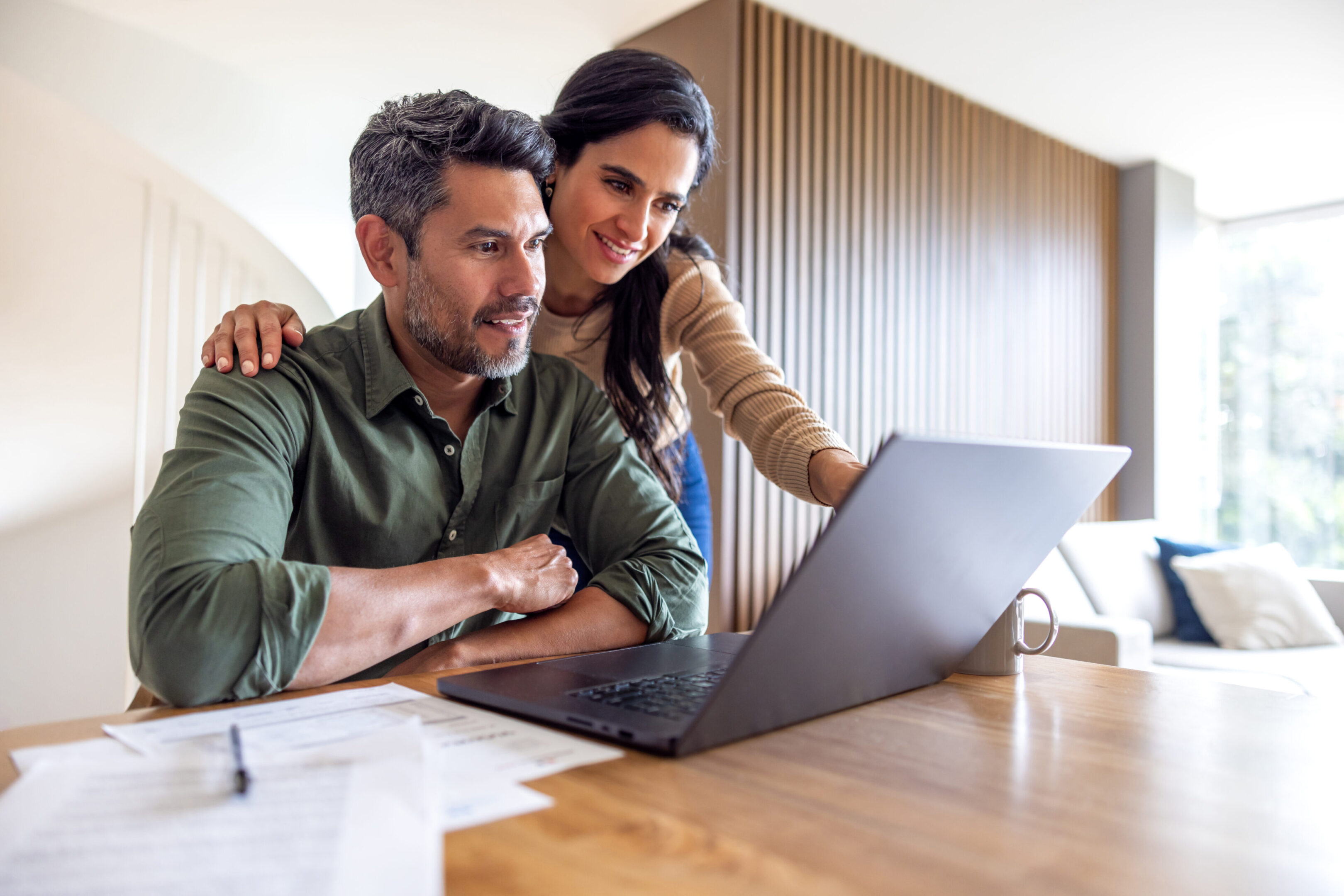 Man and woman using computer at home
