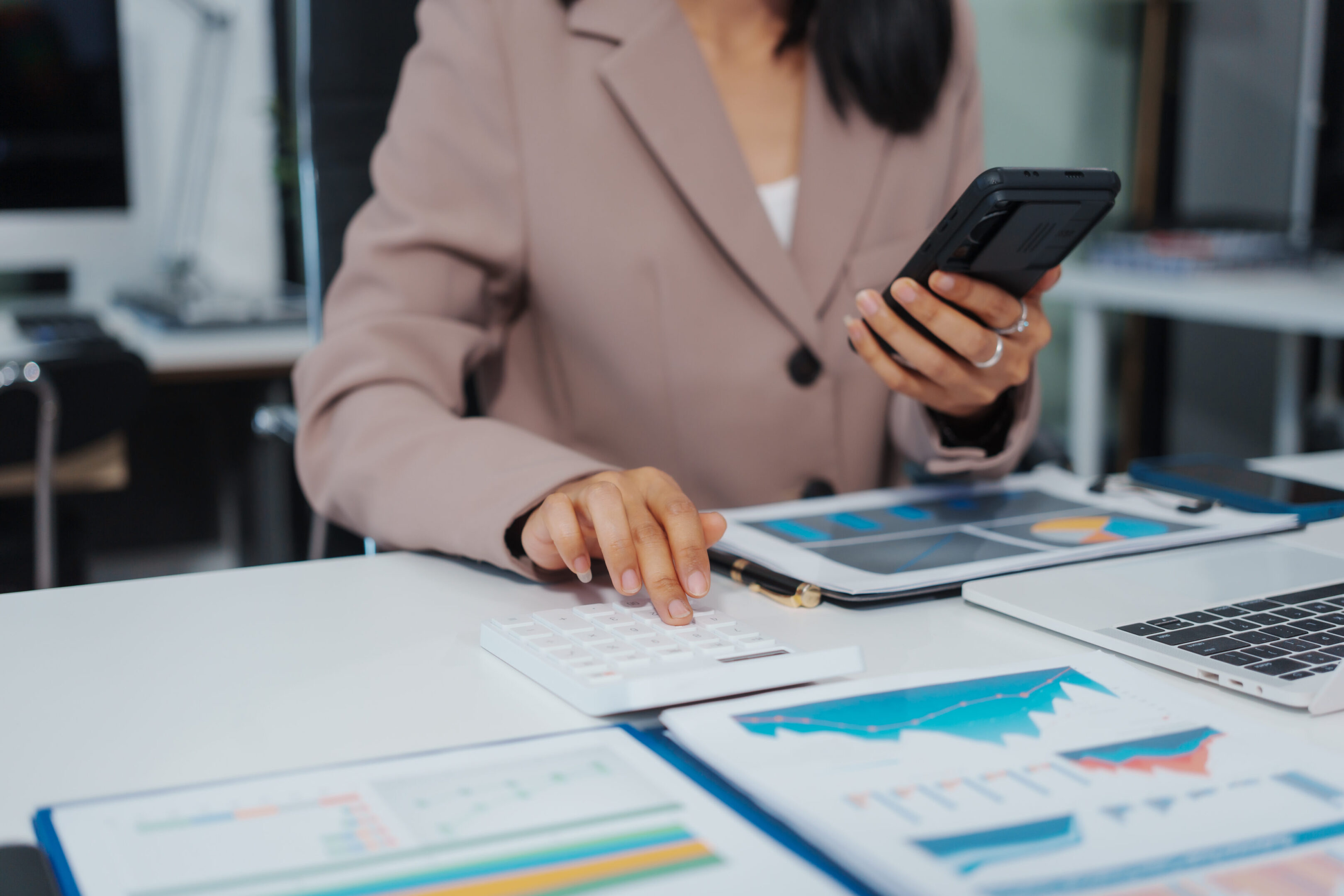 Businesswoman analyzing financial charts and graphs
