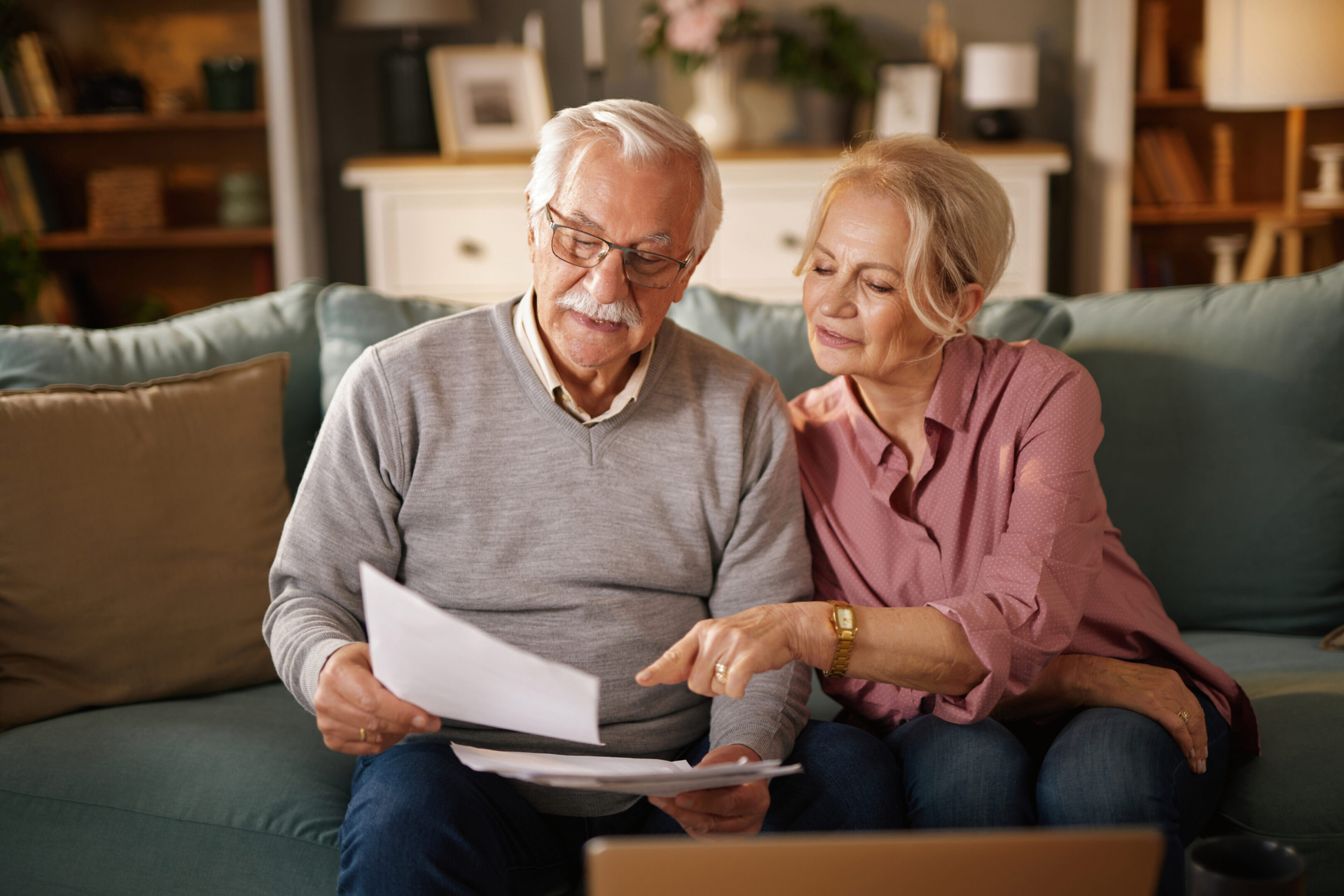Seniors discussing paperwork at home
