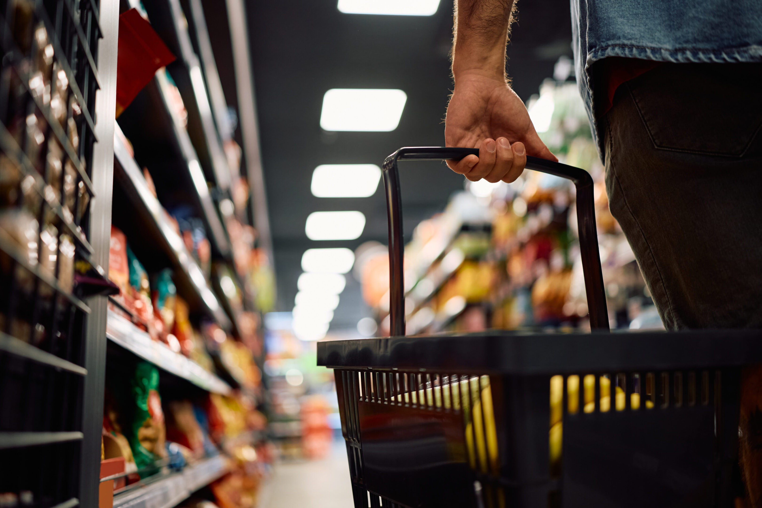 Shopping basket in grocery store aisle
