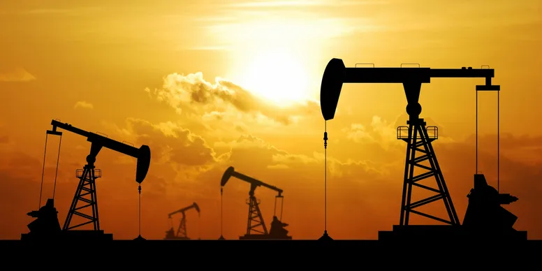 Pumpjacks operating at sunset in silhouette